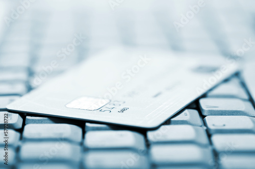 Photo: Credit card on a computer keyboard. Shallow depth of field Credit card on a computer keyboard. Shallow depth of field