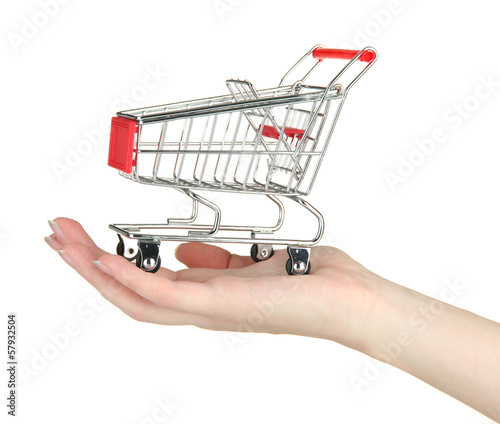 Photo: empty shopping trolley on woman hand, isolated on white empty shopping trolley on woman hand, isolated on white