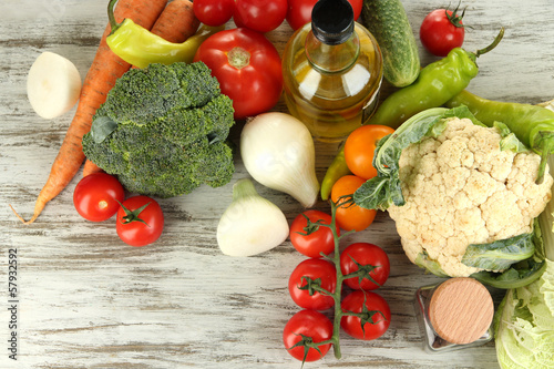 Photo: Fresh vegetables in basket on wooden table close-up Fresh vegetables in basket on wooden table close-up
