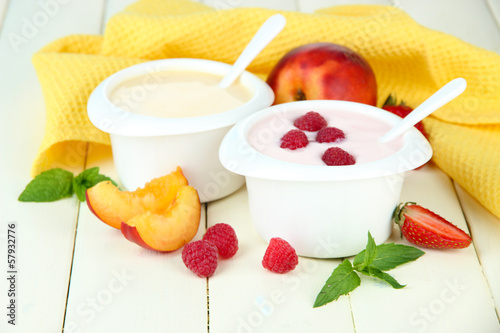 Photo: Delicious yogurt with fruit and berries on table close-up Delicious yogurt with fruit and berries on table close-up