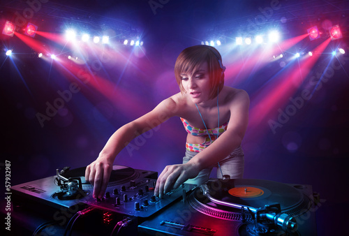 Photo: Teenager Dj mixing records in front of a crowd on stage Teenager Dj mixing records in front of a crowd on stage