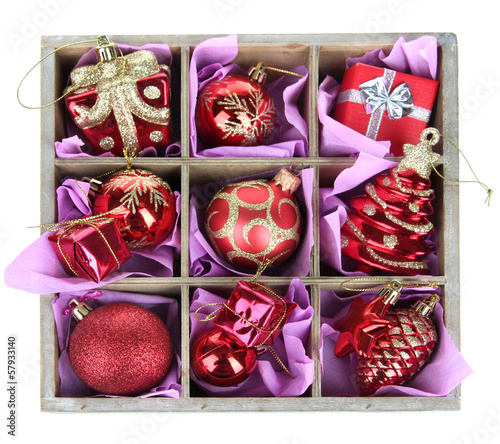 Photo: Christmas toys in wooden box isolated on white Christmas toys in wooden box isolated on white