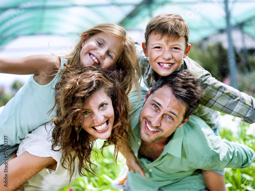 Photo: family having fun in a greenhouse family having fun in a greenhouse