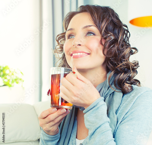 Photo: Beautiful Girl Enjoying Coffee. Woman with Cup of Hot Beverage Beautiful Girl Enjoying Coffee. Woman with Cup of Hot Beverage