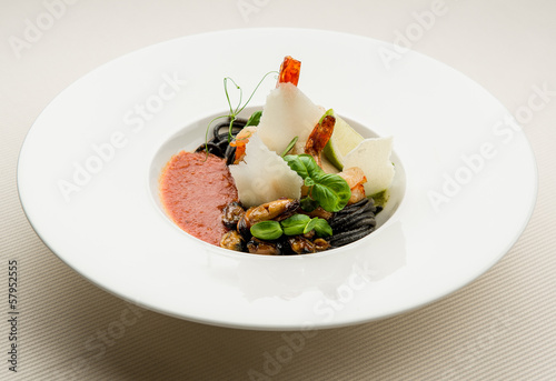 Photo: Black spaghetti with seafood,parmesan and tomato sauce Black spaghetti with seafood,parmesan and tomato sauce