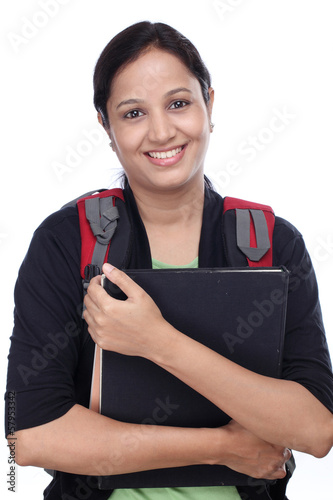 Photo: Happy young female student with books and backpack Happy young female student with books and backpack