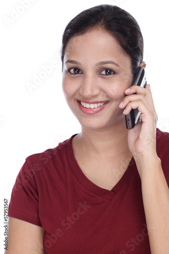 Photo: Young Indian girl talking on cell phone Young Indian girl talking on cell phone