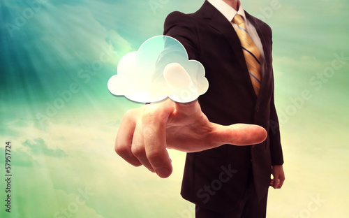 Photo: Businessman pressing a cloud computing icon Businessman pressing a cloud computing icon