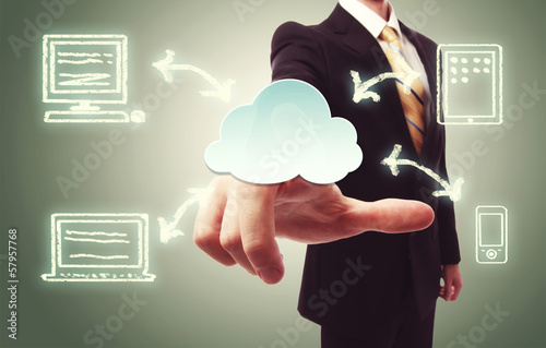 Photo: Businessman pressing cloud icon Businessman pressing cloud icon