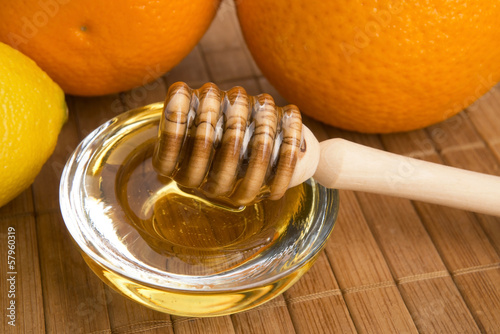 Photo: fresh honey with lemon and orange fruits fresh honey with lemon and orange fruits