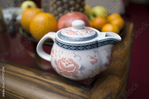 Photo: Chinese teapot and fruits on coffee table. Chinese teapot and fruits on coffee table.