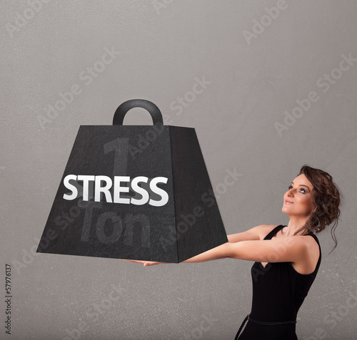 Photo: Young woman holding one ton of stress weight Young woman holding one ton of stress weight