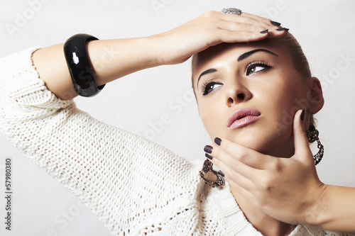 Photo: Beautiful woman in woolen dress.Jewelry and Beauty.hairless Beautiful woman in woolen dress.Jewelry and Beauty.hairless