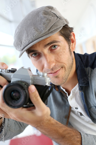 Photo: Photographer in studio using old-fashioned camera Photographer in studio using old-fashioned camera
