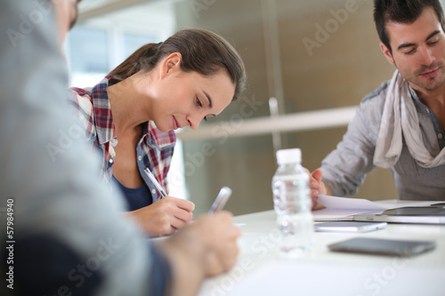 Photo: Students in class writing on notebooks Students in class writing on notebooks