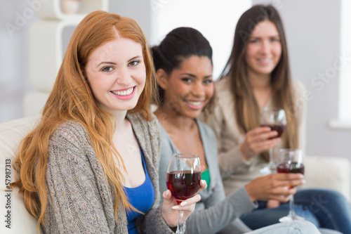 Photo: Smiling female friends with wine glasses at home Smiling female friends with wine glasses at home