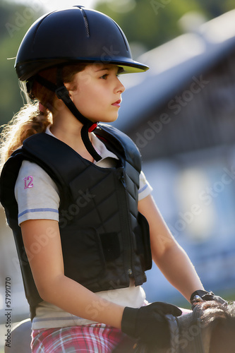 Photo: Horse riding, portrait of lovely equestrian on a horse Horse riding, portrait of lovely equestrian on a horse
