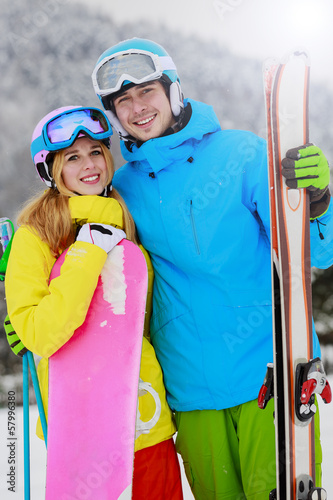 Photo: Ski and fun, young couple enjoying winter holiday Ski and fun, young couple enjoying winter holiday