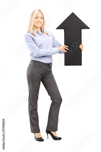 Photo: Full length portrait of a blond smiling woman holding am arrow Full length portrait of a blond smiling woman holding am arrow