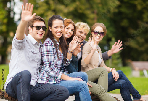Photo: group of students or teenagers waving hands group of students or teenagers waving hands