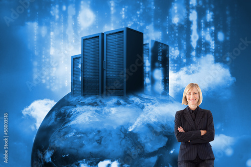 Photo: Composite image of friendly businesswoman smiling at the camera Composite image of friendly businesswoman smiling at the camera