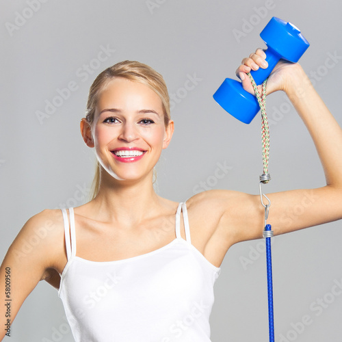 Photo: Woman exercising with dumbbells and growth Woman exercising with dumbbells and growth