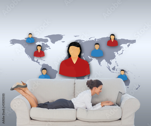 Photo: Composite image of business woman lying on couch Composite image of business woman lying on couch