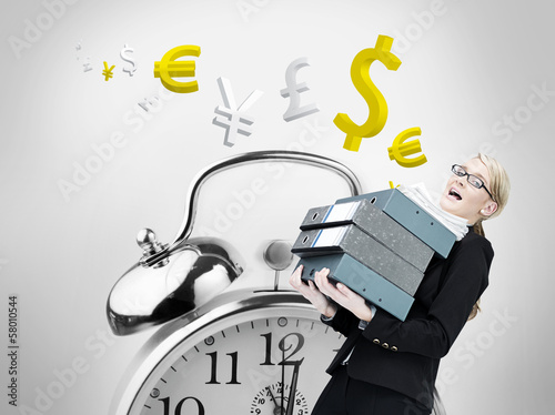Photo: Composite image of businesswoman carrying folders Composite image of businesswoman carrying folders