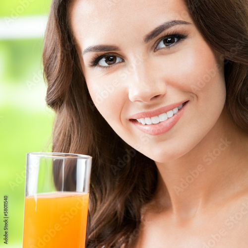 Photo: Happy woman drinking juice Happy woman drinking juice