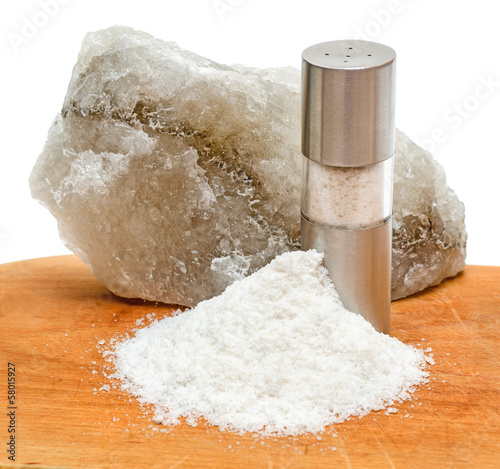 Photo: Rock salt with saltshaker and scattered salt Rock salt with saltshaker and scattered salt