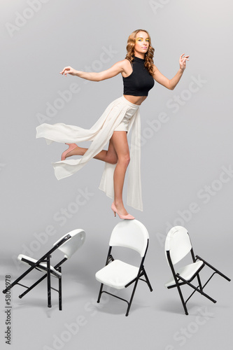 Photo: Fashionable woman balancing Fashionable woman balancing