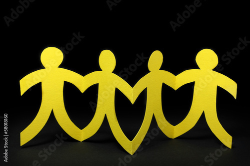 Photo: yellow paper people on black background yellow paper people on black background