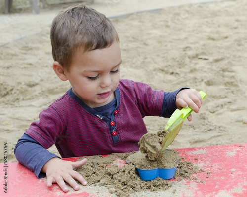 Photo: Child playing in sandpit Child playing in sandpit