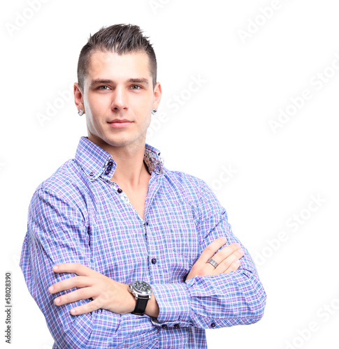 Photo: Casual young man looking at camera with arms crossed Casual young man looking at camera with arms crossed