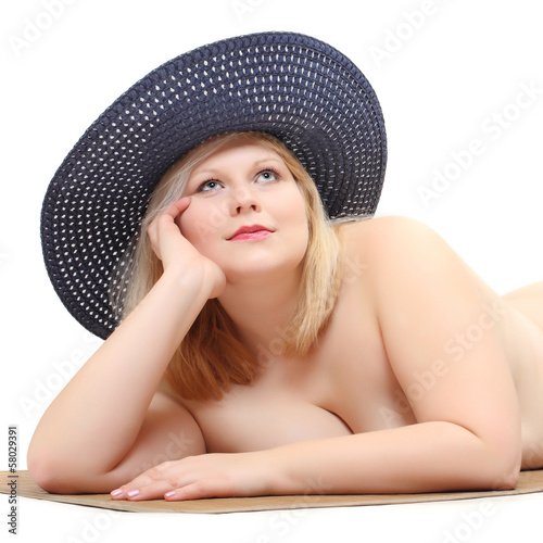 Photo: Overweight woman in straw hat sunbathing. Sun protection. Overweight woman in straw hat sunbathing. Sun protection.