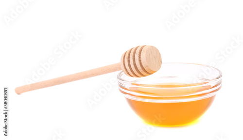 Photo: Bee honey with wooden dipper Bee honey with wooden dipper