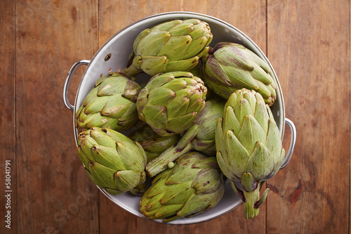 Photo: Raw pile of artichokes on colander Raw pile of artichokes on colander