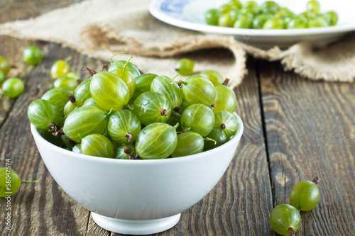 Photo: Green gooseberries in a white bowl Green gooseberries in a white bowl