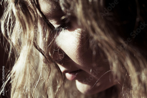 Photo: Sad beautiful woman looking down Sad beautiful woman looking down