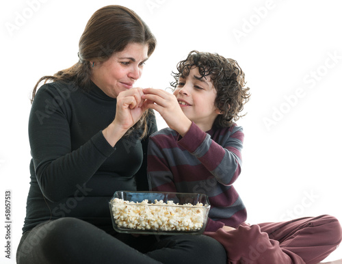 Photo: Single mom and son eating popcorn Single mom and son eating popcorn