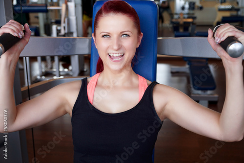 Photo: lachende Frau trainiert im Fitnessstudio lachende Frau trainiert im Fitnessstudio