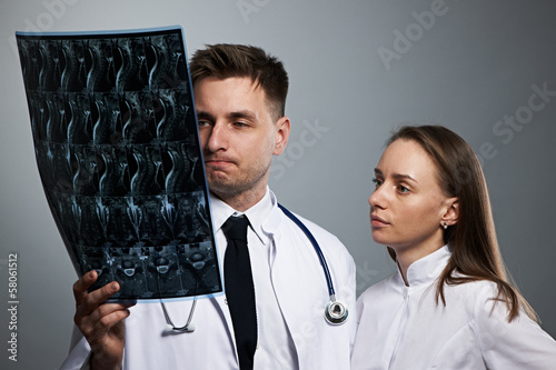 Photo: Medical doctors team with MRI spinal scan Medical doctors team with MRI spinal scan