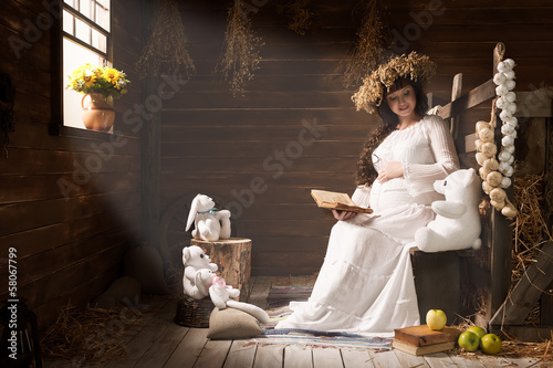 Photo: Portrait of a young pregnant woman in a village hut Portrait of a young pregnant woman in a village hut