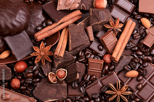 Photo: Background from slices of chocolate, coffee, nuts and spices Background from slices of chocolate, coffee, nuts and spices