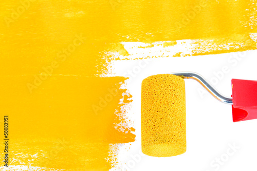 Photo: Roller brush with yellow paint Roller brush with yellow paint