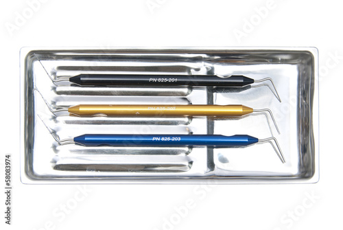 Photo: Metallic dentist tools close up in a dentist clinic. Metallic dentist tools close up in a dentist clinic.