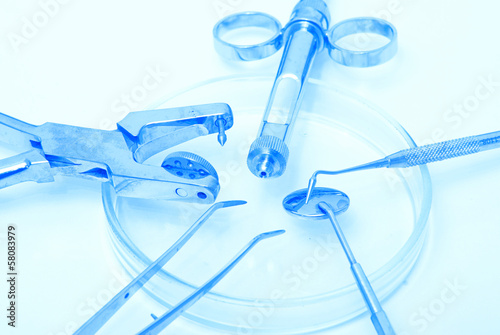 Photo: Metallic dentist tools close up in a dentist clinic. Metallic dentist tools close up in a dentist clinic.