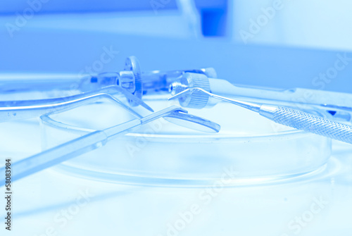 Photo: Metallic dentist tools close up in a dentist clinic. Metallic dentist tools close up in a dentist clinic.