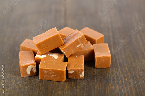 Photo: Many toffee on wooden table Many toffee on wooden table