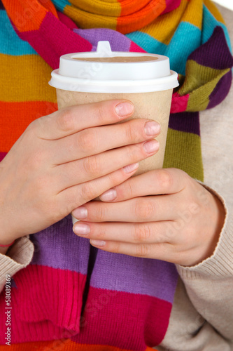 Photo: Hot drink in paper cup in hands close up Hot drink in paper cup in hands close up